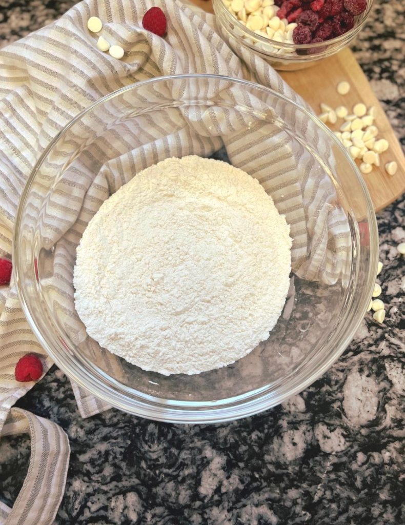 Flour and other ingredients mixed together in a glass bowl. 