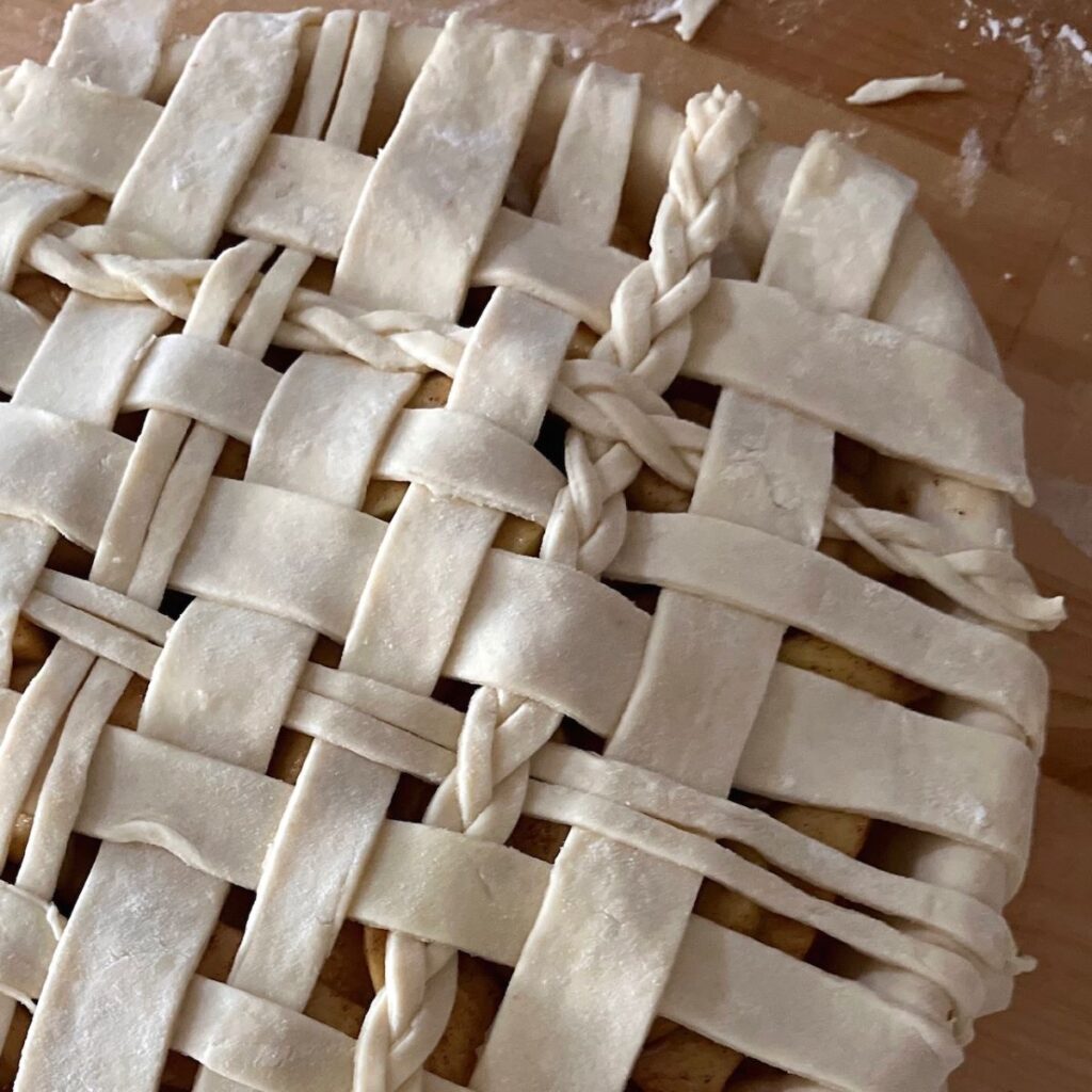 An unbaked lattice pie crust with braids
