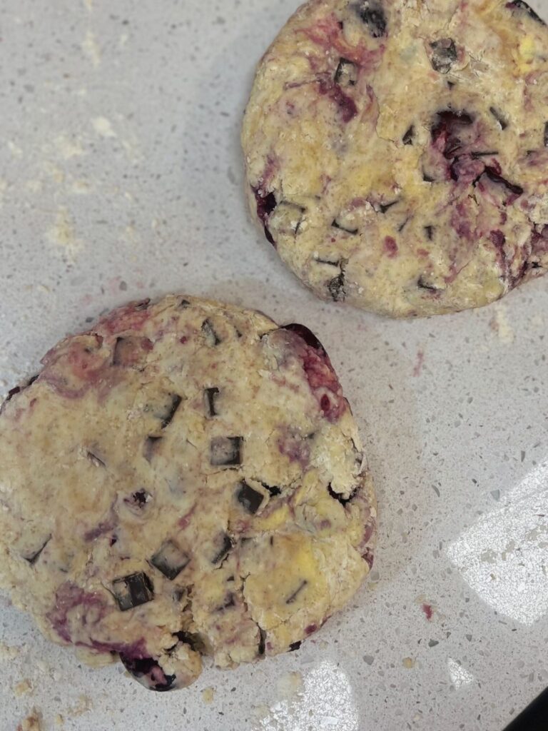Two disks of scone dough on a countertop.
