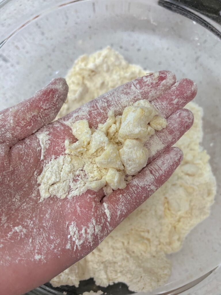 Pieces of butter in chunks with dry ingredients.