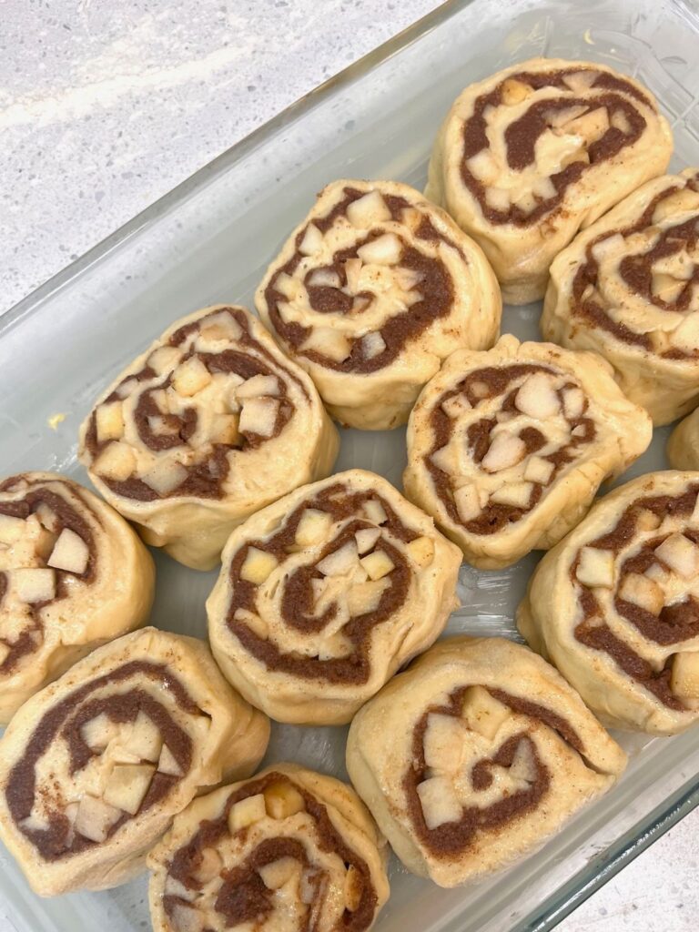 Sourdough apple cinnamon rolls in a baking dish.