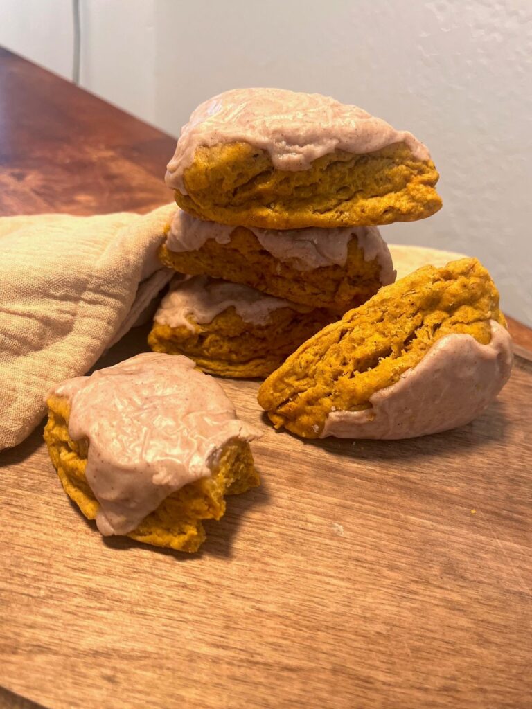 A stack of scones on a cutting board with a cloth.